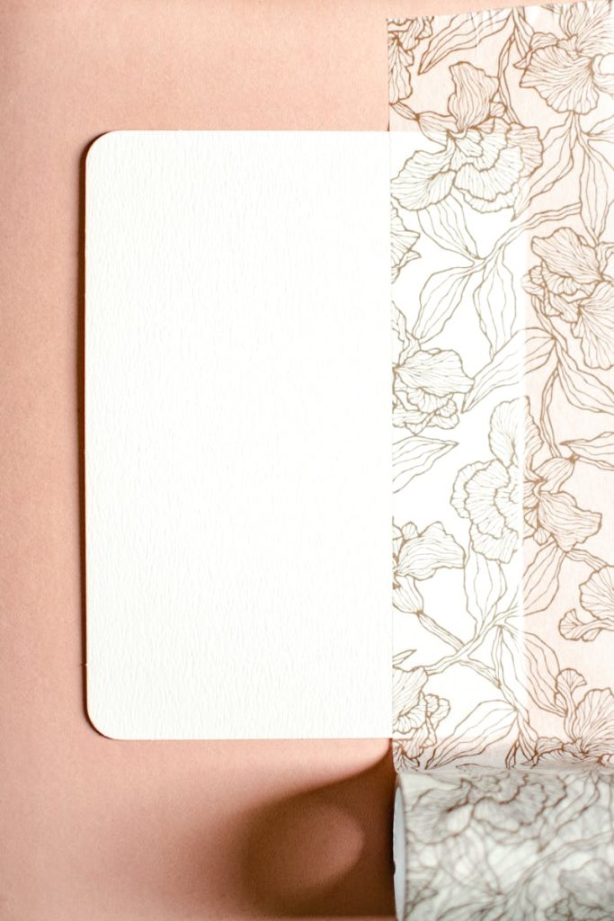 Contactar con Estampación Miñarro A minimalist floral design mockup with elegant patterns on textured paper, perfect for art and design projects.