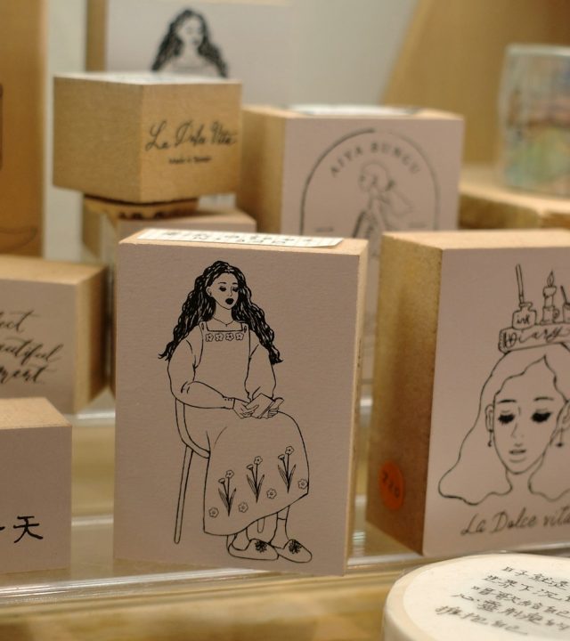 Wooden stamps with line drawings of women and text.